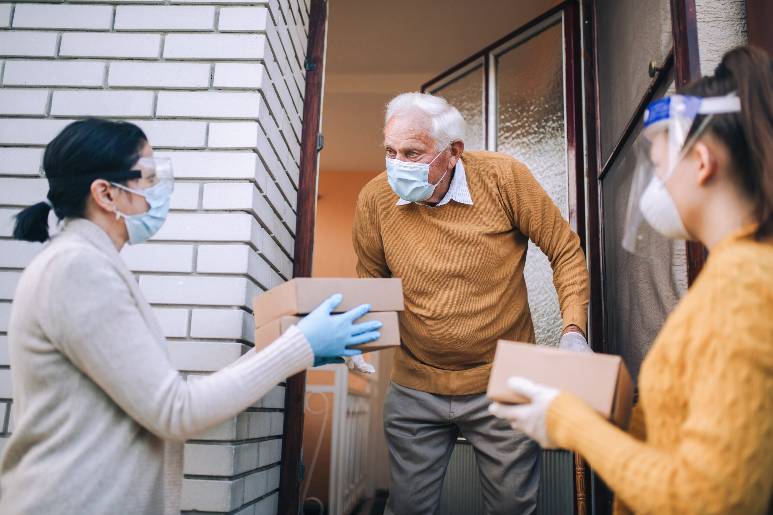 women delivering to elderly person